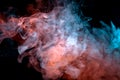 Background of orange, purple, red and blue wavy smoke on a black isolated ground. Abstract pattern of steam from vape of smoothly Royalty Free Stock Photo