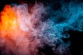 Background of orange, purple, red and blue wavy smoke on a black isolated ground. Abstract pattern of steam from vape of smoothly Royalty Free Stock Photo