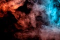 Background of orange, purple, red and blue wavy smoke on a black isolated ground. Abstract pattern of steam from vape of smoothly Royalty Free Stock Photo