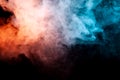 Background of orange, purple, red and blue wavy smoke on a black isolated ground. Abstract pattern of steam from vape of smoothly Royalty Free Stock Photo