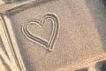Background with painted heart on sand, concept of love, copy space Royalty Free Stock Photo