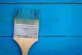 Background with paintbrush in blue paint on the wooden just painted boards Royalty Free Stock Photo