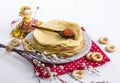 Background with pancakes, textile doll, sushki, pussy-willow and spoon with caviar on white for Maslenitsa festival