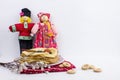 Background with pancakes, textile dolls, sushki, wooden spoon with caviar and pussy-willow for Maslenitsa festival.