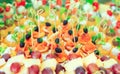 Background of party appetizers on wooden sticks.