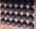 Background Pattern Of Multiple Black Audio Speakers. Woofers Are Arranged Neatly On Wooden Surface. Royalty Free Stock Photo