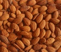 Background pattern, raw peeled almonds situated chaotically.