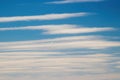 Background photo: blue sky and white clouds in the form of stripes. Blurred. Royalty Free Stock Photo