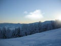 Background photo of low clouds in a mountain valley, vibrant blue and orange sky. Sunrise or sunset view of mountains and peaks Royalty Free Stock Photo