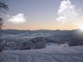 Background photo of low clouds in a mountain valley, vibrant blue and orange sky. Sunrise or sunset view of mountains and peaks Royalty Free Stock Photo