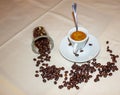 Background, photograph of a linen cloth with a cup of espresso coffee with a teaspoon inside and coffee beans placed in a corner Royalty Free Stock Photo