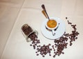 Background, photograph of a linen cloth with a cup of espresso coffee with a teaspoon inside and coffee beans placed in a corner Royalty Free Stock Photo