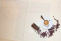 Background, photograph of a linen cloth with a cup of espresso coffee with a teaspoon inside and coffee beans placed in a corner Royalty Free Stock Photo