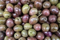 Background of pickled green and pink olives. closeup