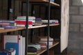 Side view with copy space pile of books in wooden rack at a modern indoors library