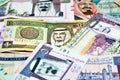 Background of a pile of Saudi Arabia riyals banknotes money bills of different values from different times