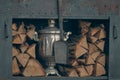 Vintage samovar next to wooden logs Royalty Free Stock Photo