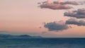 Background of pink clouds in evening sky over sea, twilight fairy sunset, copy space Royalty Free Stock Photo