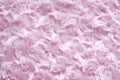 Background of pink faux fur with curls
