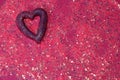 background with pink glitter and heart in the upper right corner