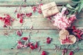 Background with pink peony, peonies petals, gift box and a wooden heart on old green boards Royalty Free Stock Photo