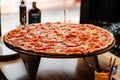 Background pizza. Hot big pepperoni pizza tasty pizza composition with melting cheese bacon tomatoes ham paprika Royalty Free Stock Photo