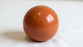The background is plain emphasizing the ball s simplicity and polished texture Royalty Free Stock Photo