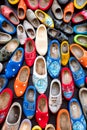 Background of Popular souvenirs - Old wooden Dutch shoes - klomps. A lot of colorful old clomps against the background of a wooden Royalty Free Stock Photo