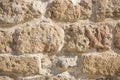 Background porous stone structure, fragment of an ancient stone wall in Jaffa, Israel