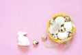 Background with quail eggs in the basket, rabbit and feathers. Royalty Free Stock Photo