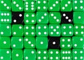 Background of random ordered green dices with three black cubes Royalty Free Stock Photo