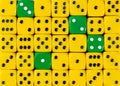 Background of random ordered yellow dices with four green cubes Royalty Free Stock Photo