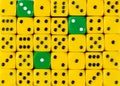 Background of random ordered yellow dices with three green cubes Royalty Free Stock Photo