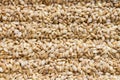 Background of raw dry grains of pearl barley decomposed by furrows Royalty Free Stock Photo