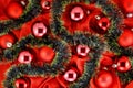 Background of red Christmas tree balls with gold and green decorations on red silk fabric Royalty Free Stock Photo