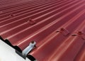 Background of red corrugated sheet metal. Sheet metal roof or corrugated roofs of factory or warehouse building. Galvanize steel Royalty Free Stock Photo