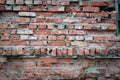 Background of red cracked weathered old wrecked uneven rough brick wall, pattern, grunge surface, texture