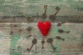 Background with red heart and antique keys on old painted wooden