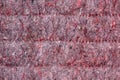 Background of red lining with fibers from non-uniform fabric. Texture of grey felt material Royalty Free Stock Photo