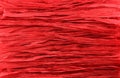 Background - red paper raffia strips situated in parallel lines