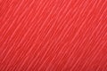 Background of red pressed corrugated paper with a diagonal texture taken close up