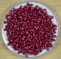 Background of red ripe pomegranate seeds on a plate. Raw organic fruits vegetables. Royalty Free Stock Photo