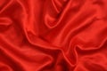 Background red satin fabric with folds. Curtains and textiles Royalty Free Stock Photo