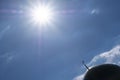 Silhouette of the minaret of the Islamic mosque against the background of the sky with a bright sun. Diagonal direction in the fra