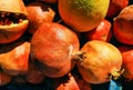 Background of ripe torn pomegranates and an orange in the oriental market. Fruit prepared for making freshly squeezed juice