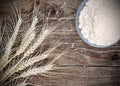 Background ripe wheat ears and white flour on old vintage wooden table Royalty Free Stock Photo