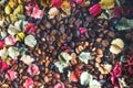 background of roasted coffee beans with colourful dried Potpourri Royalty Free Stock Photo