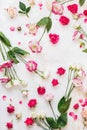Background with roses and lisianthus or Japanese roses flowers scattered on rustic background