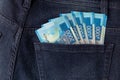 Bunch of Rouble banknotes of Russia in the back pocket of a blue jeans.