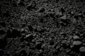 Background of rough, grainy stone or sand in black or dark gray Royalty Free Stock Photo